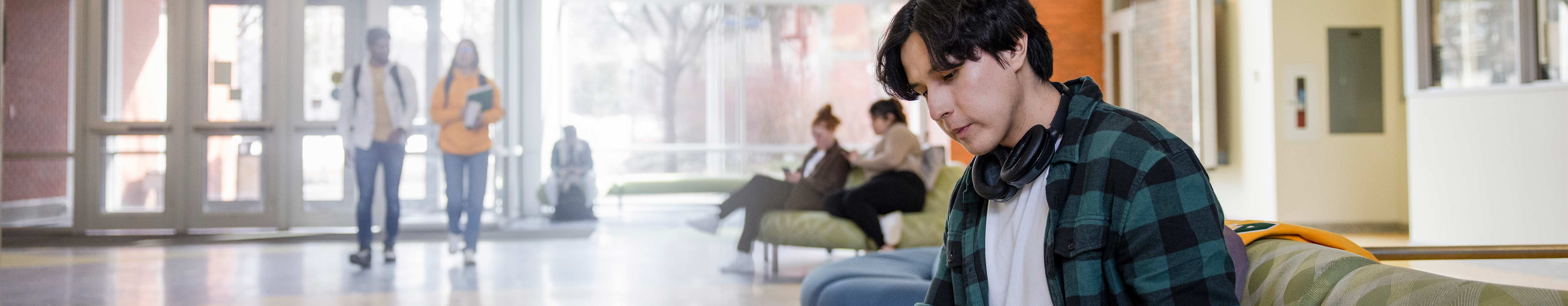 Student sitting on a couch studying
